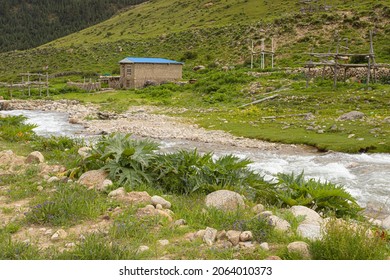 Blue Hut Beside A Stream In Ganzi Tibetan Autonomous Prefecture