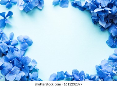 Blue Hydrangea Flowers On Blue Pastel Background. Floral Border. Flat Lay. 