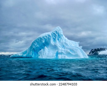 A blue iceberg drifting in the South Atlantic Ocean off the coast of South Georgia Island. - Shutterstock ID 2248794103