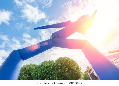 Blue Inflatable Air Dancer Outdoors In The Sunlight