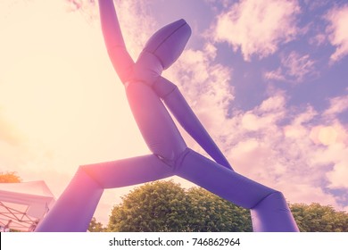 Blue Inflatable Air Dancer In The Sunlight Outdoors