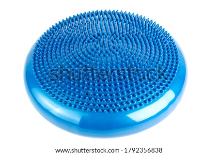 Blue inflatable balance disk isoleated on white background, It is also known as a stability disc, wobble disc, and balance cushion.