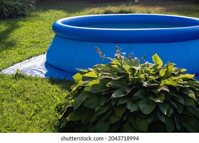 Blue Inflatable Pool On The Lawn Of Country Garden