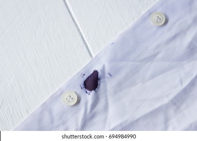 Blue Ink Stain On White Shirt With Wood Table Background, Daily Life Stains In Living 