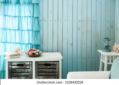 Blue interior of beach house with nautical decor. Copy space