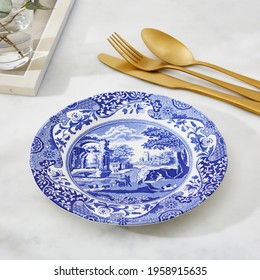 Blue Italian dinner plate with gold fork - Powered by Shutterstock