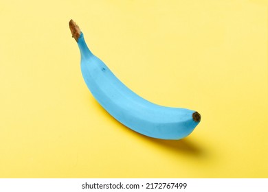 Blue java banana on pastel yellow background