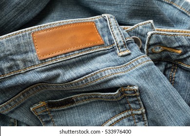 jeans with brown tag on back pocket