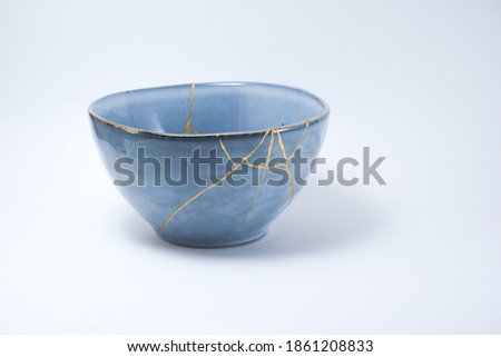 Blue kintsugi bowl, Gold cracks restoration, Pottery fixed with the antique Japanese Kintsugi restoration technique. The beauty of imperfections