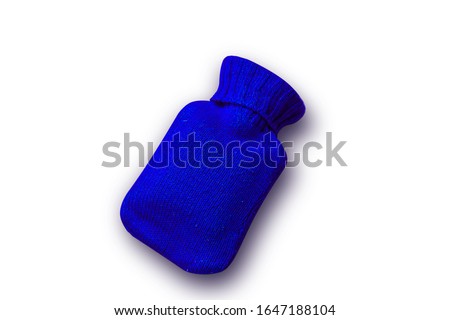 blue knit hot water bottle  on pink background.