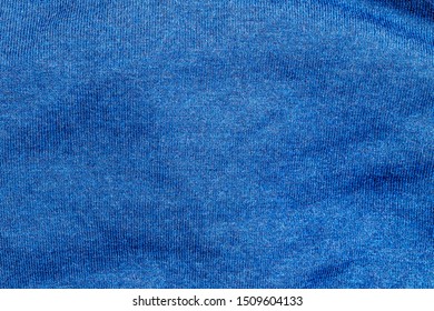 Blue Knitted Pullover Background, Close Up. Knitted Cloth Texture Of Princess Blue Color Yarn. Fine-knit Pure Cashmere Jumper. Soft Blue Angora Background, Closeup