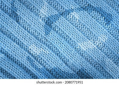 Blue knitted textured background with a pattern closeup