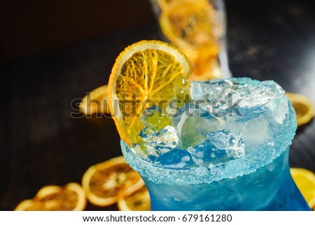 blue lagoon cocktail closeup on dark background