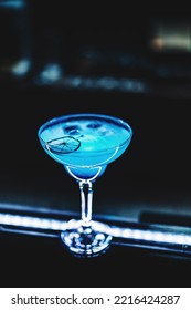 Blue Lagoon Cocktail With Blue Curacao Liqueur, Vodka, Lime Juice And Soda On Bar Counter