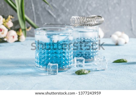 Blue Lagoon cocktails on rustic background