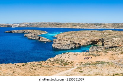 Blue Lagoon at Comino surrounded by rocky coastline seen the small Maltese island in April 2022 