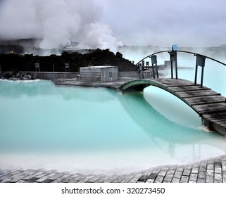 Blue lagoon, with its iconic bridge, revealing the stunning and tranquil beauty of its blue waters in Iceland, a natural wonder and tourist attraction - Shutterstock ID 320273450
