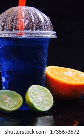 Blue Lagoon With Orange Mocktail In Black Background 