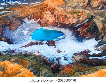 Blue lake in the crater of Gorely volcano in Kamchatka peninsula, Russia. Aerial drone view. Beautiful landscape at sunrise.