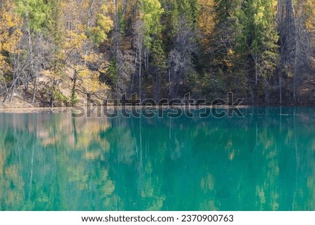 Blue Lake, the source of the Red Key in Bashkortostan, deciduous and coniferous trees around it.