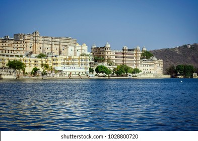 Blue lake water and blue sky with a lovely view of City Palace Udaipur.