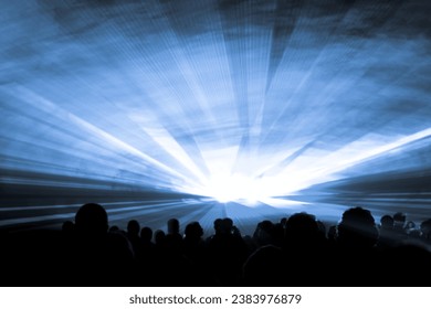 Blue laser show nightlife club stage with party people crowd. Luxury entertainment with audience silhouettes in nightclub event, festival or New Years Eve. Beams and rays shining colorful lights - Powered by Shutterstock