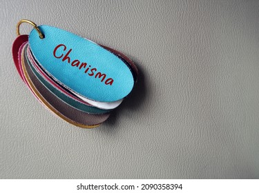 Blue Leather On Copy Space Gray Background With Handwritten Text CHARISMA, Refers To People Who Have Naturally Ability To Influence Others, Magnetic Charm Which Attract Attention And Admiration