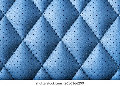 Blue leather texture pattern. Quilted textile material with stitching. Detailed square upholstery background. Soft surface with perforation. Elegant abstract fabric design. Interior decor texture.