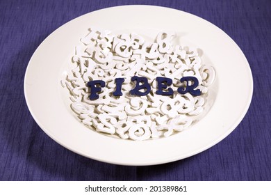 Blue letters in white bowl of white letters spelling Fiber.
