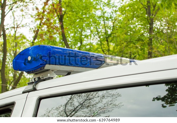 Blue light bar on the police\
car.