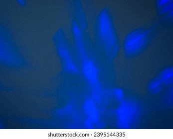 Blue light in a dark room on the wall for an abstract background, energy or mystery. - Shutterstock ID 2395144335