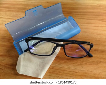 Blue Light Filter Glasses With Case On Wooden Table