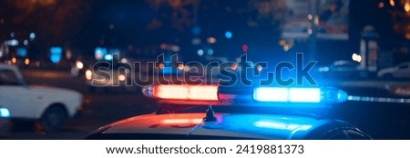Blue light flasher atop of a police car
