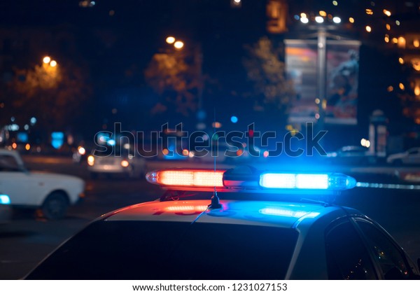 Blue light flasher\
atop of a police car\

