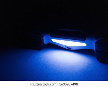 Blue light game controller in the dark.