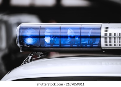 A Blue Light On Top Of A Police Car