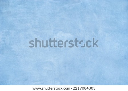 Blue light painted wall texture background.