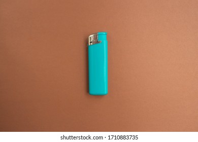  Blue Lighter With A Button On A Brown And White Background. Top View. Mock Up. Flat Lay Composition.