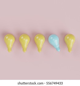 Blue lighting bulb one different from yellow bulbs on pinks background. minimal concept. top view.