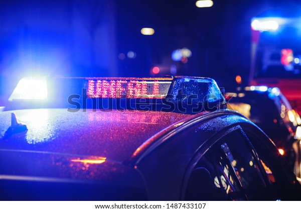 Blue lights of a german police\
car and a sign which shows \