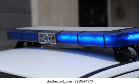 Blue Lights On Roof Of Police Car In City