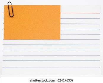 Blue Lined Index Card With Orange Notecard Attached With Red Paperclip. Isolated.