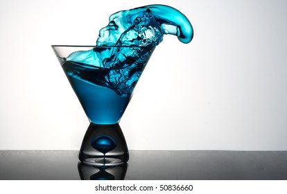 Blue Liquid Pouring Out Of Martini Glass