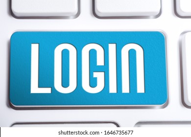 Blue Login Button On A White Keyboard