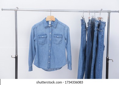 Blue Long Sleeve Jeans Shirt And Four Blue Jeans On Hanger