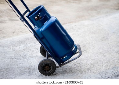 Blue LPG gas cylinder tank on small cart to make delivery to local customers in rural of Thailand. Concept : Energy saving. Gas for cooking in daily life. Gas tank used with stove.      - Shutterstock ID 2160800761