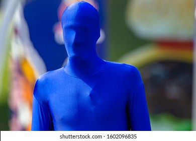 Blue Man Head To Feet Covered In Full Lycra Body Suit Material Outdoor Event Closeup Photo.