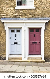 Blue And Maroon Neighboring Front Doors