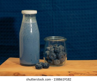 Blue Matcha And Blueberry Smoothie Drink In Glass Bottle. Anchan Powder Smoothie Drink. Blue Background. Still Life