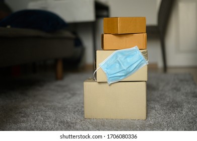 Blue Medical Mask Attached To The Package For Delivery In Selective Focus, Concept Safe Delivery, Protection Virus, Heal Care, Aid